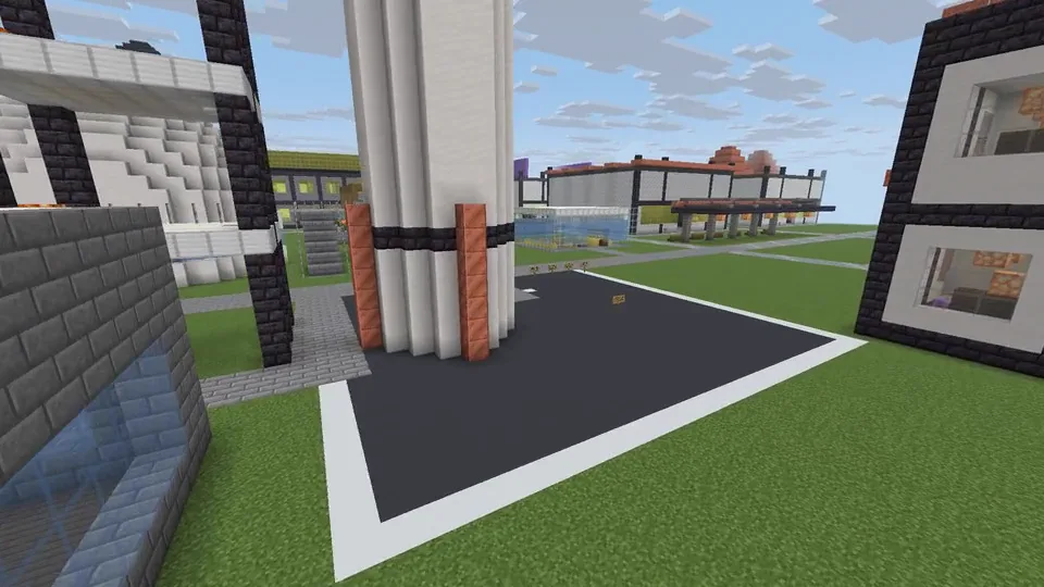 Real in-game capture from an automated test run, spectator camera: the launch gantry, the rocket standing on its pad and the science city on Earth, HUD hidden.
